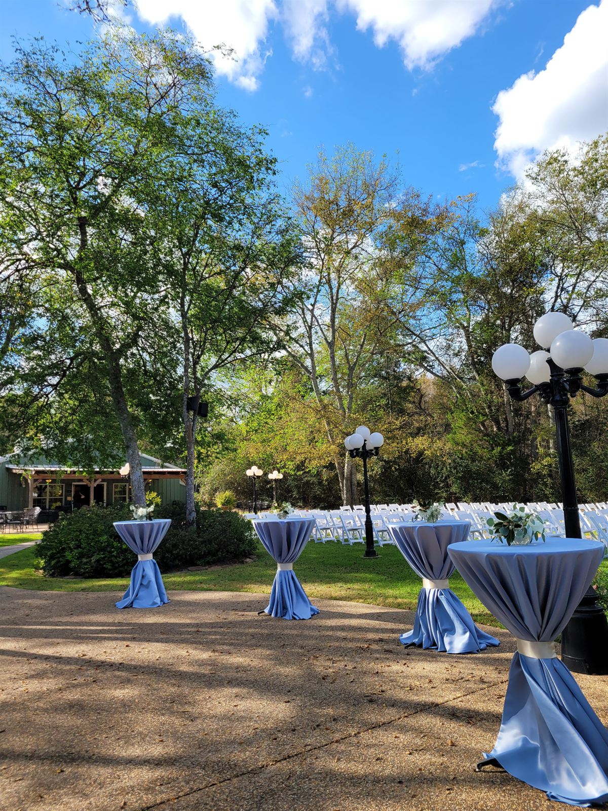 Cocktail tables in blue with ceremony seating beyond