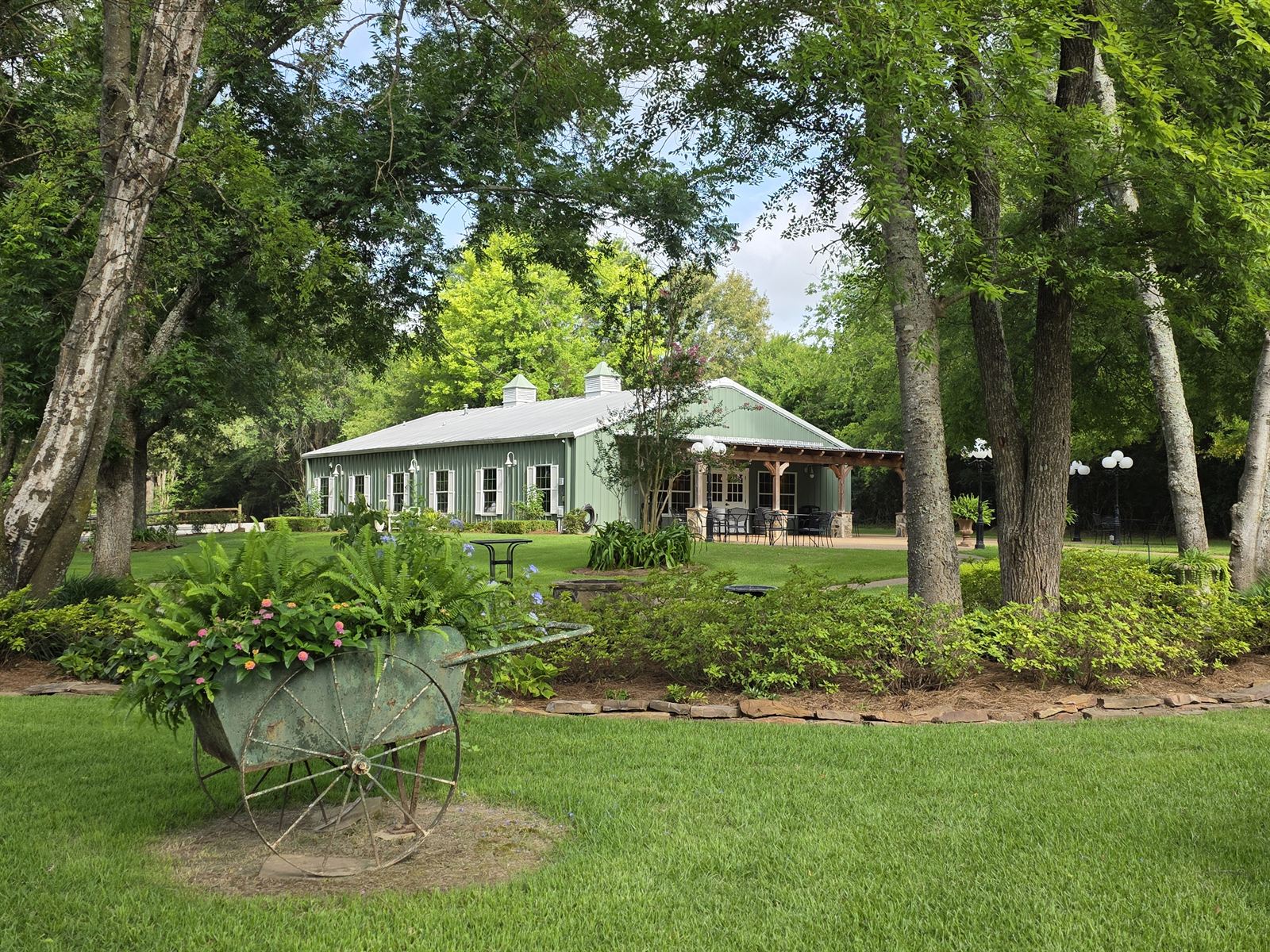 Miss Mary's Hall exterior with antique wheelbarrow planter